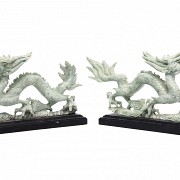 A pair of dragons on wooden base.