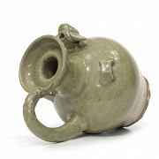Yue style ceramic jug glazed in green.