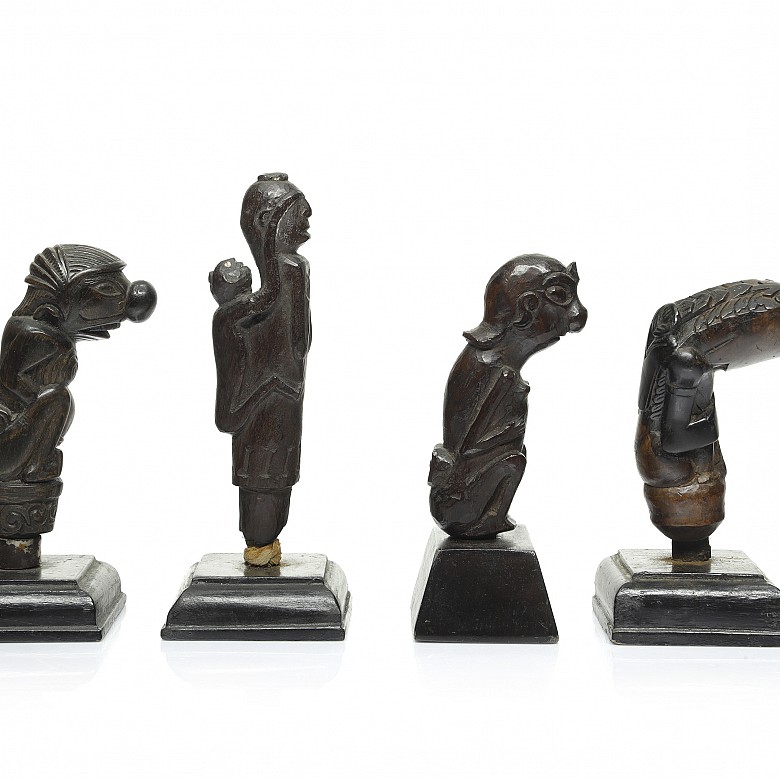Four wooden Kris handles, Indonesia, 19th - 20th century