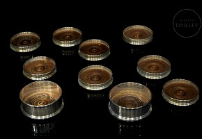 Eight coasters and two bottle holders in English silver