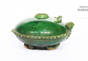 Green vessel in the shape of a turtle.