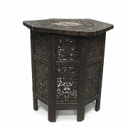 Carved wood table with a base, 20th century