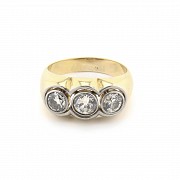18k gold ring with three diamonds.